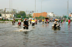 Residents in Ho Chi Minh City, Vietnam in the middle of flooding season. Flooding is just one of Vietnam’s environmental challenges.