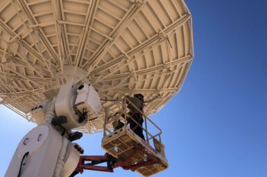 CfAT technicians put the finishing touches on the satellite dish for the earth ground station in Alice Springs. Image: Ekistica Ltd.