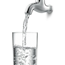 water from tap filling glass