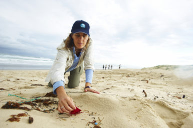 CSIRO researcher collecting rubbish on the beach
