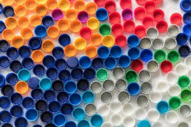 Image of plastic bottle caps all the same size in a variety of colours