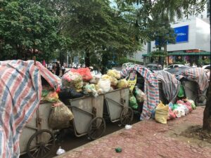 piles of rubbish in large bins