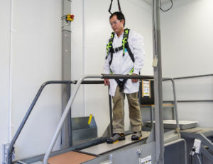 researcher in a harness on the slip test machine