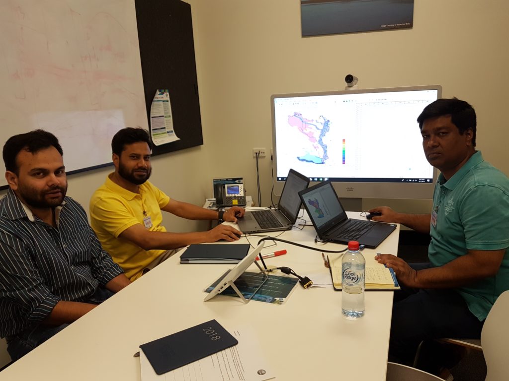 Sreekanth Janardhanan (CSIRO – at left) is with Tohid Islam and Monirul Islam (IWM – centre and at right) in the CSIRO Brisbane office and exploring surface water model outputs for the SDIP Bangladesh project. 