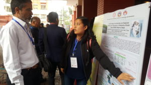 Ms Sunita Shrestha, explains her poster to conference attendee