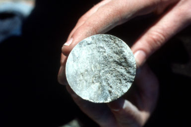 Mine core sample cross section held in a hand