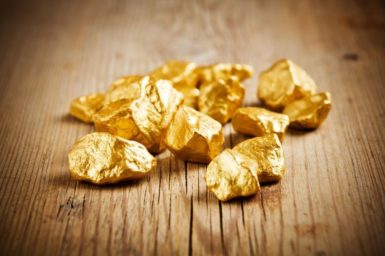 Gold nuggets on a wooden table