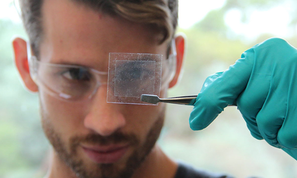 Man with beard looking at a graphene piece
