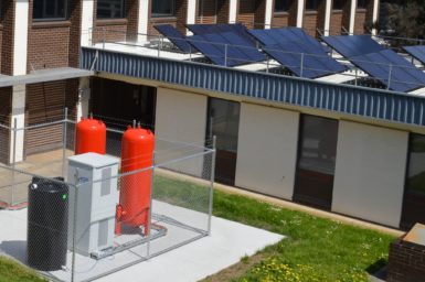 Power storage tanks outside a home with solar panels