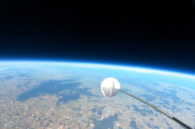 Stratospheric balloon in space with earth horizon in the background