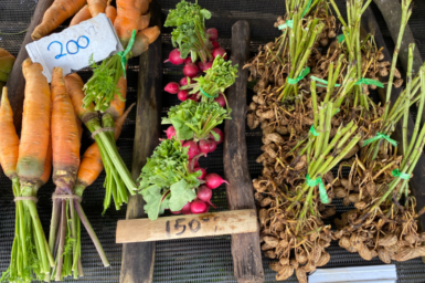 Vegetables (carrot, radish and peanut) in a market stall.