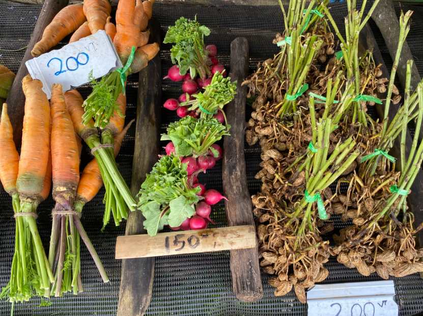 Vegetables (carrot, radish and peanut) in a market stall.